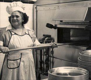 Nonna Andrisano at the pizza oven in New York